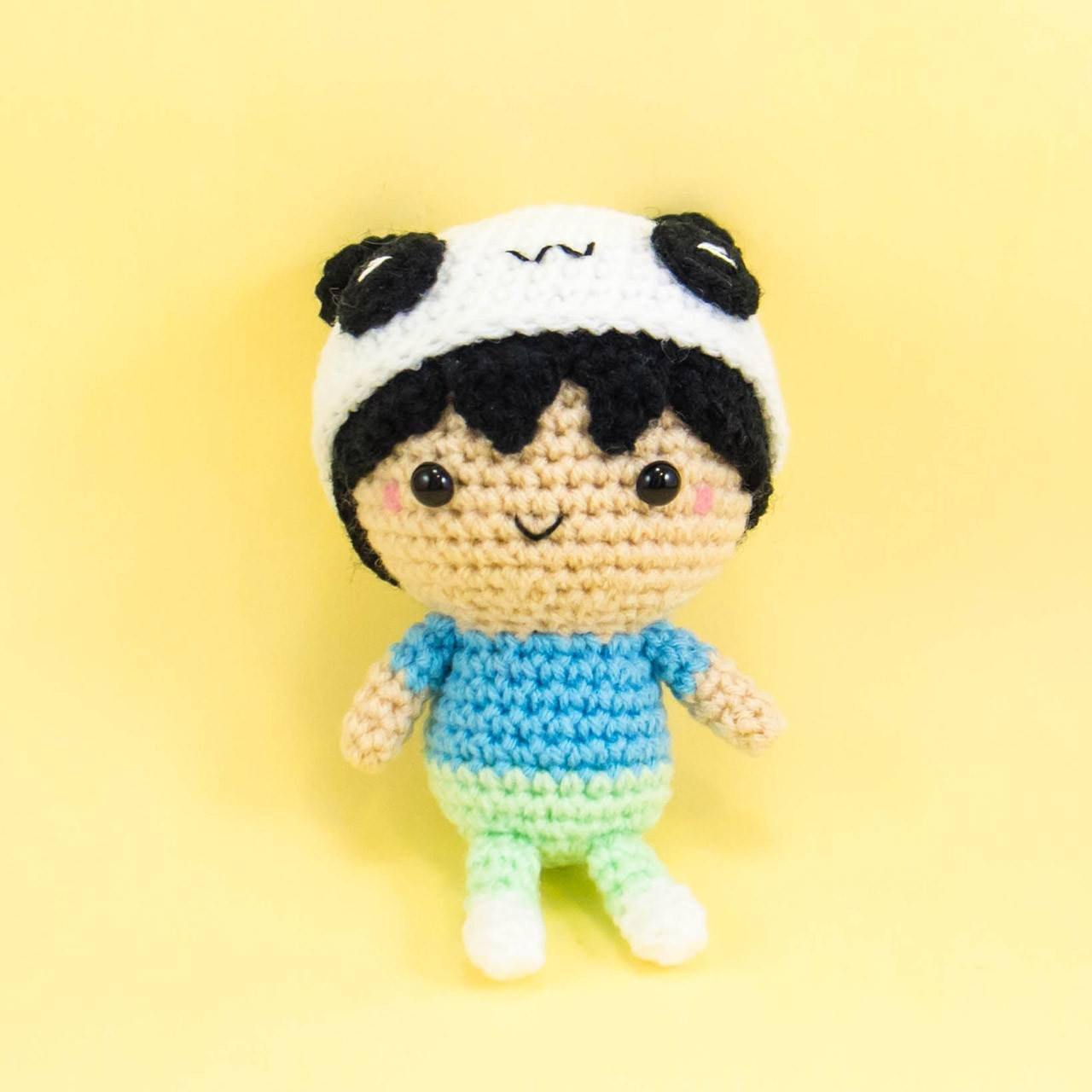 Crochet doll wearing panda hat